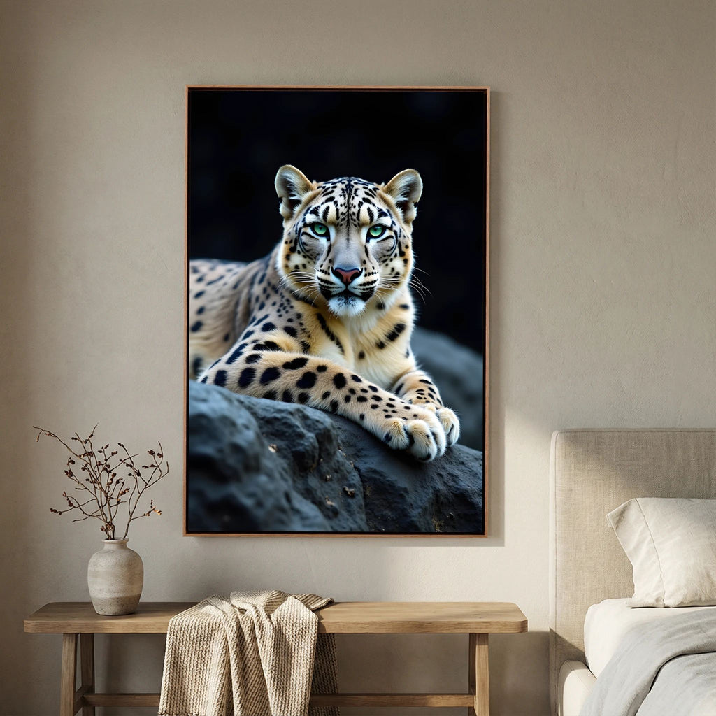 Snow Leopard Big Cat Canvas featuring a detailed close-up of a snow leopard with green eyes resting on dark rocks against a black background