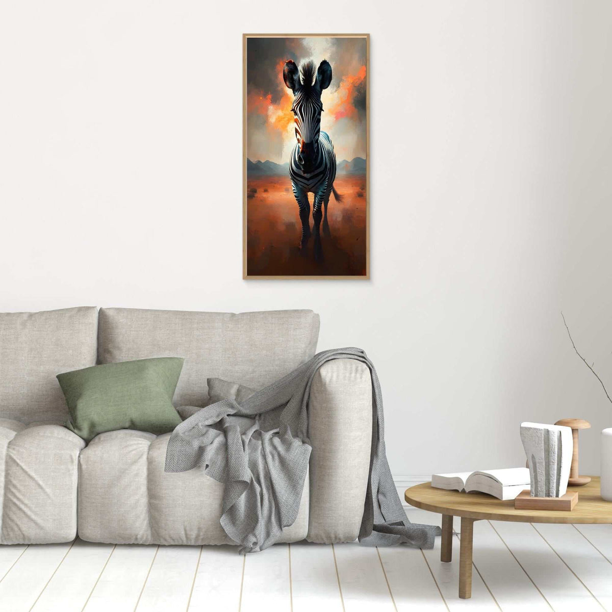 Zebra In Desert Canvas wall art featuring a monochrome zebra with warm orange and brown desert tones, framed and hanging above a neutral sofa